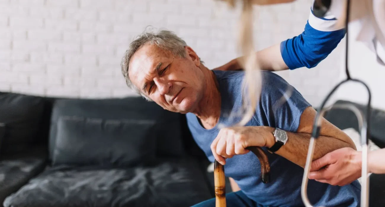 Lady Doctor guiding senior on fall prevention