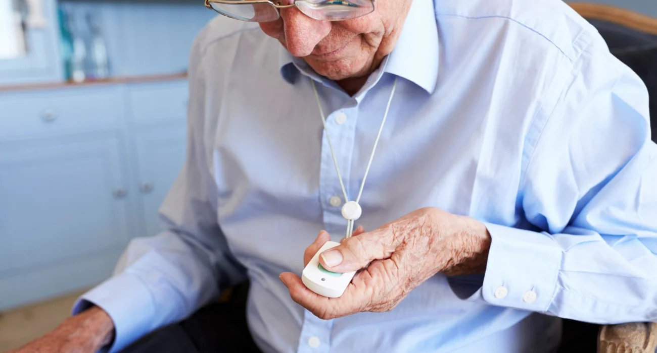 Senior using a personal emergency response system pendant
